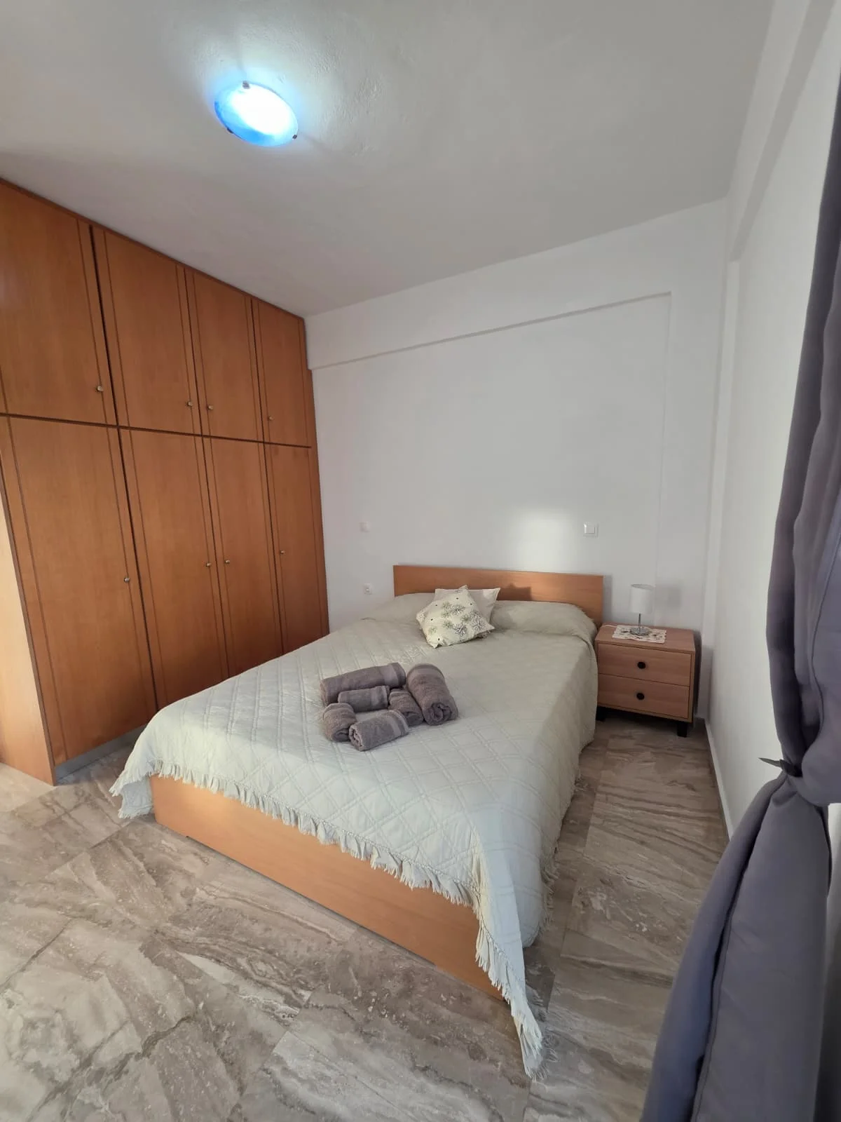 Bedroom with a double bed and wooden wardrobes