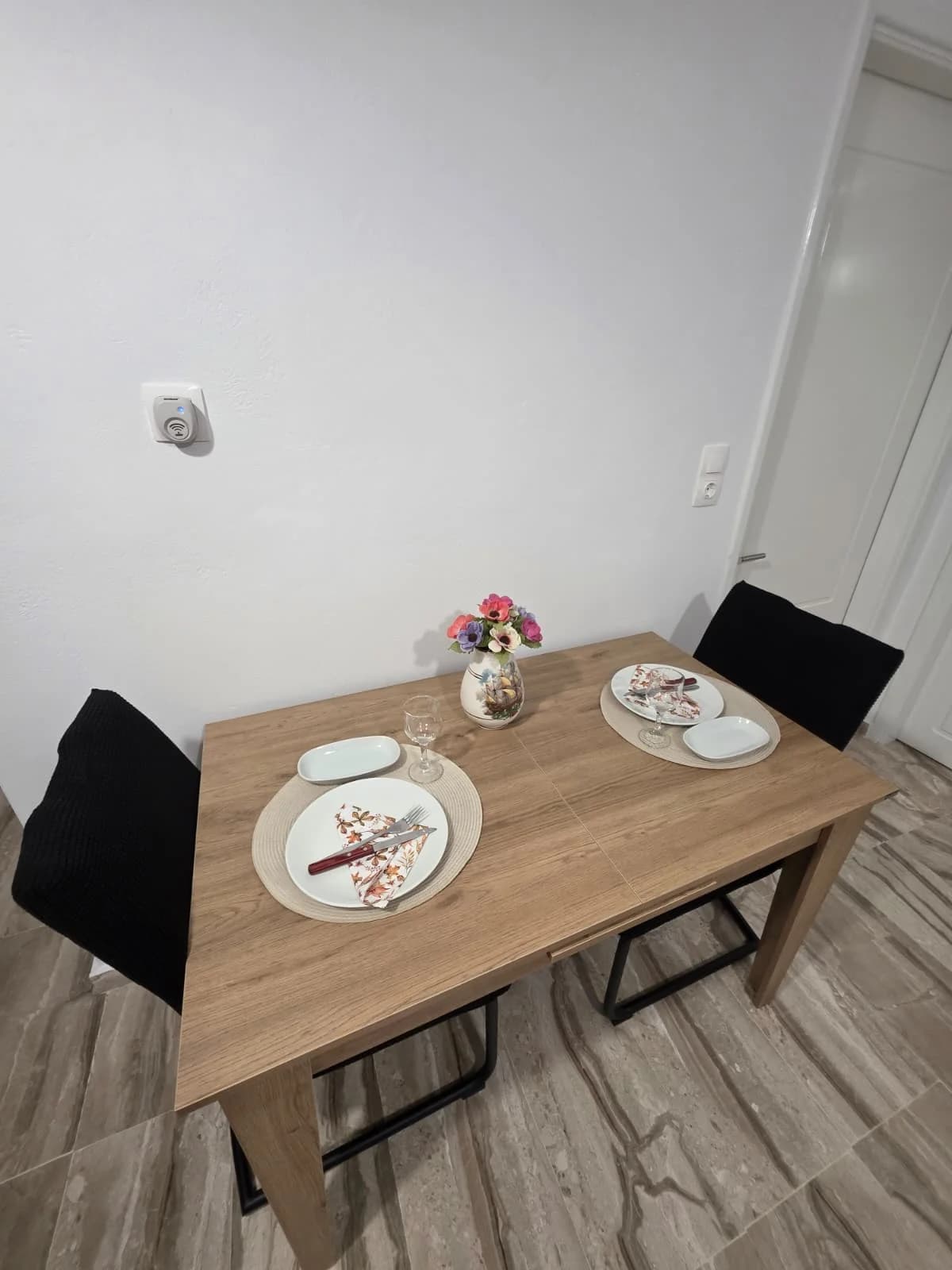 Dining table set for two inside an apartment